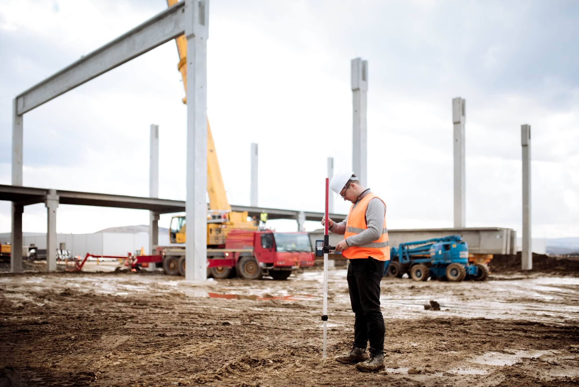 Steel and precast frame being erected on site with a crane and columns standing