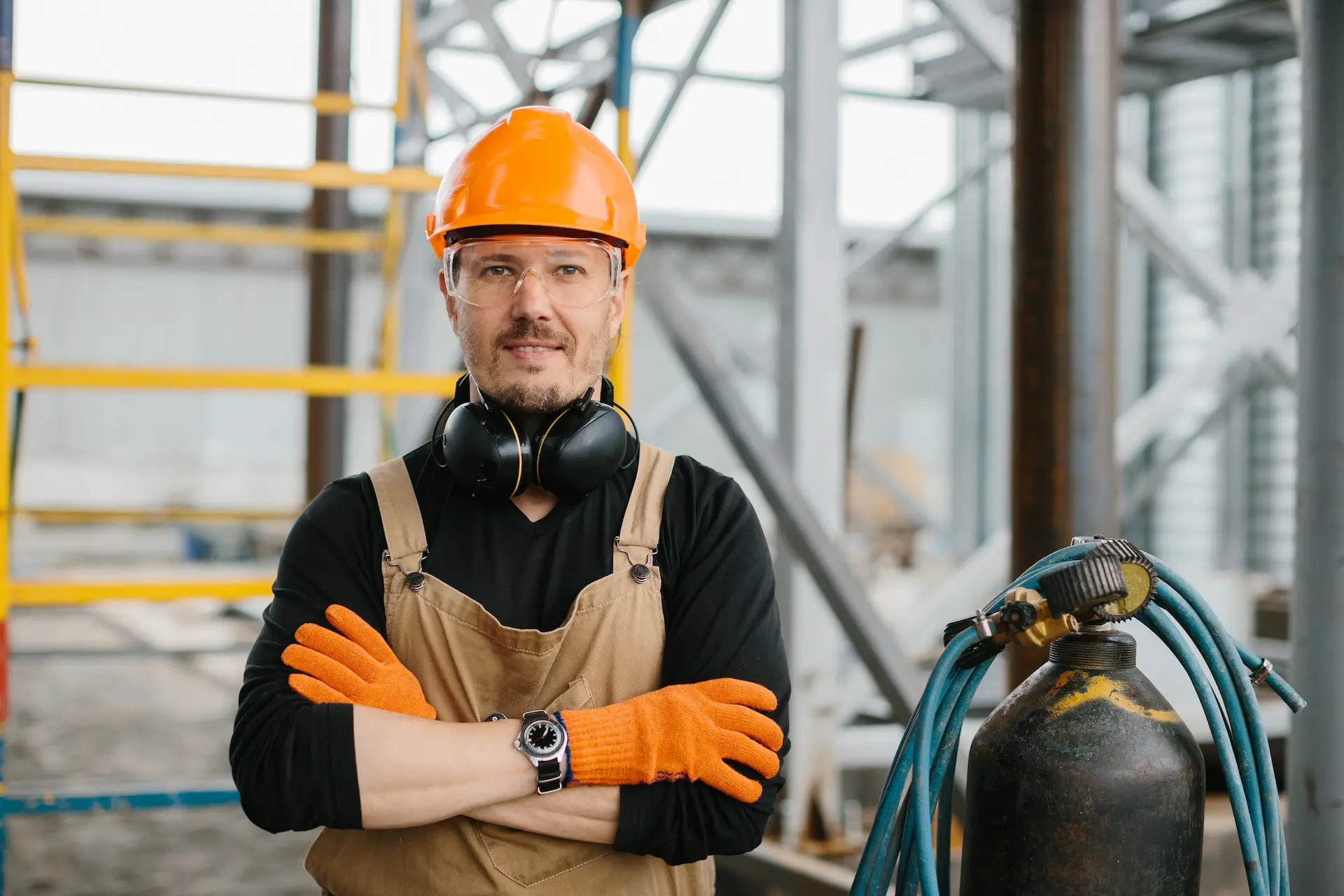 Fabrication shop worker beside gas cutting equipment in a steel fabrication facility